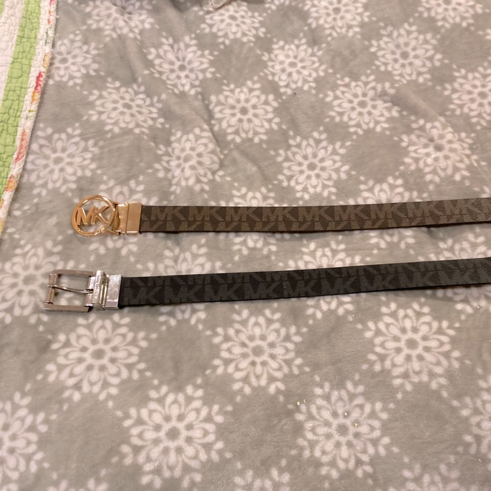 Two reversible Michael Kors belts one buckle is gold the other is silver